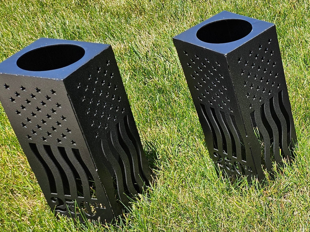 Five Iron Canvas Commemorative 250 Lanterns in Black Hammered finish displayed together on grass — group lineup showing all sides