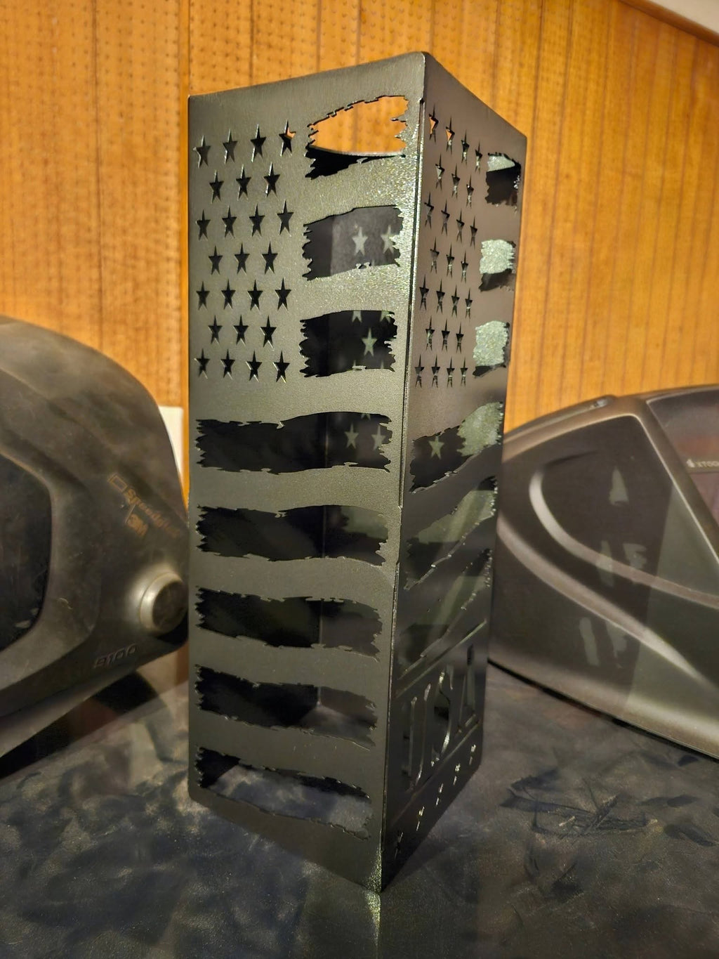 A black metal laser-cut decorative Lantern featuring an American flag pattern with stars and stripes.